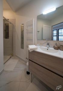 a bathroom with a sink and a shower at Suite "États Généraux" face au château - LES SUITES DE BLOIS - 4 étoiles in Blois