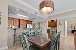 a dining room and kitchen with a table and chairs at Phoenix Gulf Shores 2102 in Gulf Shores
