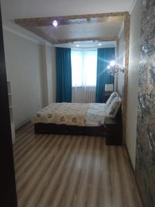 a bedroom with a bed and a large mirror at Apartment in the 7th Microdistrict in Bishkek