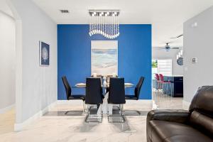 a dining room with a table and black chairs at Heated Pool Family Retreat- Games, Everglades, Keys in Miami