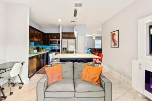 a living room with a couch and a kitchen at Heated Pool Family Retreat- Games, Everglades, Keys in Miami +31 photos