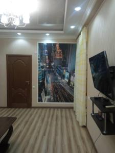 a room with a large picture of a city at Apartment in the 7th Microdistrict in Bishkek
