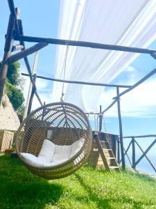 a hanging hammock with a view of the ocean at Agriturismo Sant'Alfonso in Furore