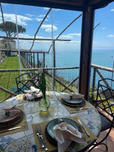 a dining table with a view of the ocean at Agriturismo Sant'Alfonso in Furore