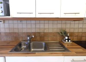 a stainless steel sink in a kitchen at Cozy 93m² Townhouse with Large Terrace & Sauna in Turku