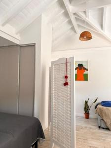 a bedroom with white walls and a bed in a room at Aloha pinot Patagonia in San Martín de los Andes