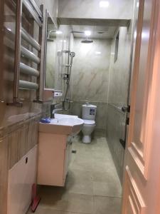 a bathroom with a sink and a toilet at Вилла в г.Кусары in Qusar