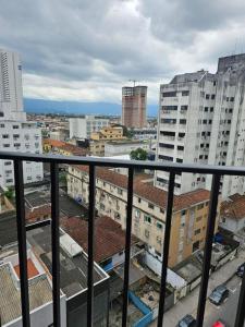 a view of a city from a balcony with buildings at Flat Palladium São Vicente in São Vicente