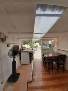 a kitchen and dining area of a house with a table at Bica da Salema Beach House in Salema