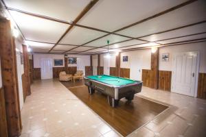 a large room with a pool table in it at Guest House Podobovets 2000 in Podobovets
