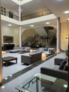 un grand salon avec des canapés et un escalier dans l'établissement Hotel San Francisco, à San Luis Potosí