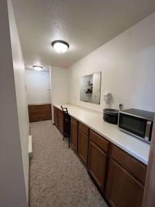 a kitchen with a counter top and a microwave at 201 E Veterans St Apt G by Patriot Properties in Tomah