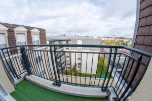 un balcón con césped verde y edificios en Paris & DisneyLand - 2min From Train Station - Free Private Parking, en Villiers-sur-Marne