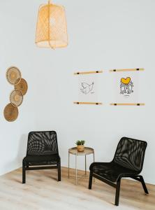 two black chairs and a table in a room at Sotiris House in Kazaphani