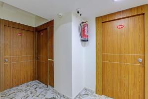a room with two wooden doors and a fire hydrant at Collection O Hotel Previliege View in Ahmedabad