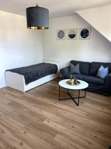 a living room with a couch and a table at Wohnung am CentrO! in Oberhausen