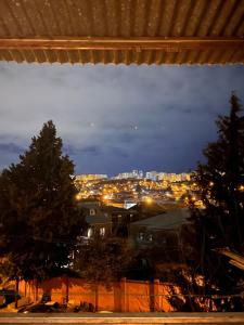 a view of a city lit up at night at Cozy apartament in Tbilisi City
