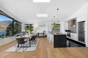 a kitchen and dining room with a table and chairs at Vanda Heights in Queenstown