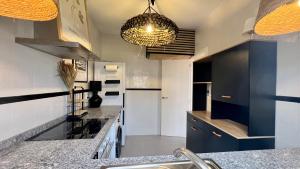 a kitchen with white and blue cabinets and a sink at Casa Pez in Ayamonte