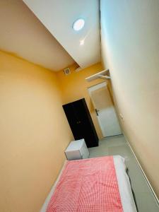 a small room with a bed and a black cabinet at AMAZING Couples private room close to Mall of Emirates in Dubai