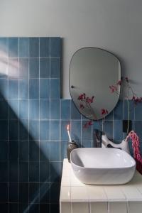 a bathroom with a sink and a mirror on a counter at Casa España in Guadalajara
