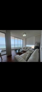 利馬的住宿－Panoramic Condominio，客厅配有白色的沙发和桌子