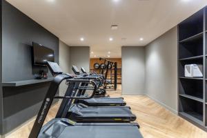 a gym with a row of treadmills in a room at Charlie JP Redenção Cidade Baixa in Porto Alegre