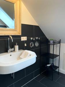 a bathroom with a sink and a mirror at SEEBADHOF - Landhaus Kaiser in Rangsdorf