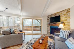 a living room with two couches and a fireplace at Timber Ridge C7 in Sugar Mountain