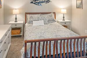 a bedroom with a bed with two night stands and two lamps at Timber Ridge C7 in Sugar Mountain