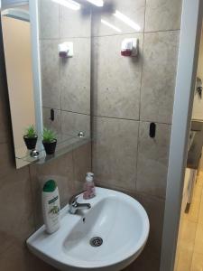a white sink in a bathroom with a mirror at Casa Playa de la Mata in La Mata
