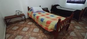 a bedroom with a bed and a night stand and a table at Ariel in Gobernador Gregores