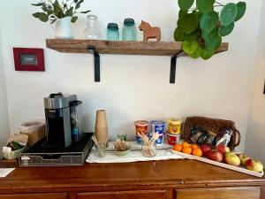 a counter with a coffee maker and fruit on it at The Griff Inn in Waitsfield