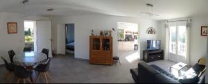 a living room with a couch and a table at Maison au calme avec jardin et piscine Saint Raphaël in Saint-Raphaël