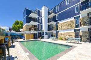 a swimming pool in front of a building at Urban Lounge Sleepery, SureStay Collection by BW in Rotorua