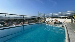 a swimming pool on top of a building at Hotel Mediterraneo Boutique in Villeta
