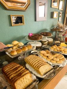 a buffet filled with different types of cakes and pies at Pousada Flor de Tuna in Urubici