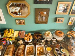 a table filled with lots of different types of food at Pousada Flor de Tuna in Urubici