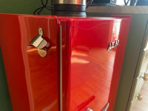 a red refrigerator with a pot on top of it at Attico White Rabbit in Turin