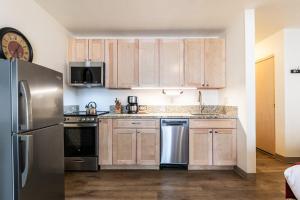 a kitchen with wooden cabinets and stainless steel appliances at Studio w/Kitchen 2nd Floor #213 at Donner Lake Village in Truckee