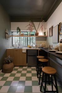 a kitchen with a checkered floor and stools at Casa España in Guadalajara