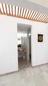 a room with a bathroom with a sink and a mirror at CASA DE PLAYA Todo el año in Punta Negra