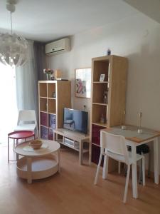 a living room with a tv and a table and chairs at Nice apartment. Chamartin. La Vaguada.P Castilla in Madrid