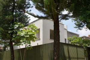 a white house with trees in front of it at Casa España in Guadalajara
