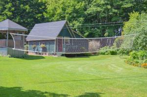 a house with a yard with a yard at Bugaboo Cottages in Summerside