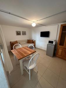 ein Wohnzimmer mit einem Holztisch und Stühlen in der Unterkunft Maiten Tempo 2 in Esquel