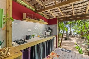 an outdoor kitchen with a counter and a stove at Fare Oaoa Haapiti in Moorea
