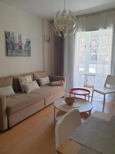 a living room with a couch and a table at Nice apartment. Chamartin. La Vaguada.P Castilla in Madrid
