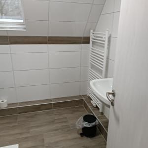 a bathroom with a bath tub and a sink at Haus Irma in Hemmingstedt