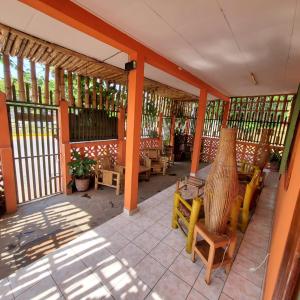 a screened in porch with chairs and tables at Casa608 in Granada